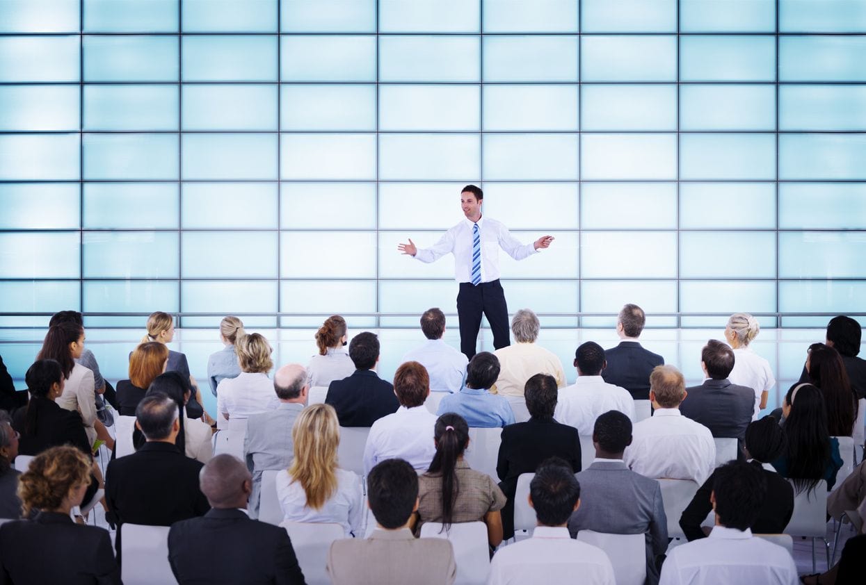 A man standing in front of a crowd of people.