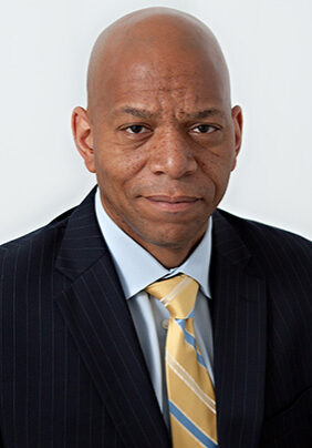 A man in a suit and tie posing for the camera.